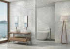 Modern bathroom with marble tiles, wooden vanity, and bathtub.