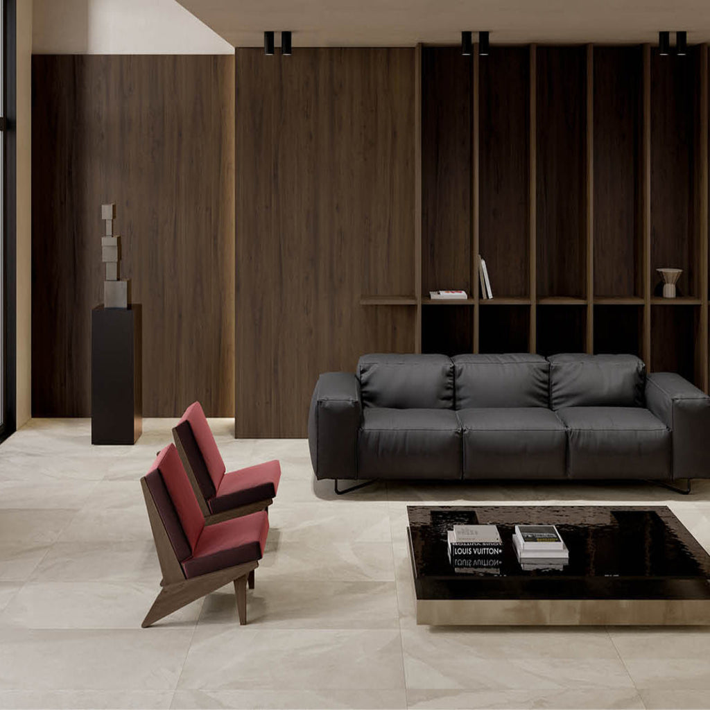 Modern living room with a black sofa, red chair, and glass coffee table.