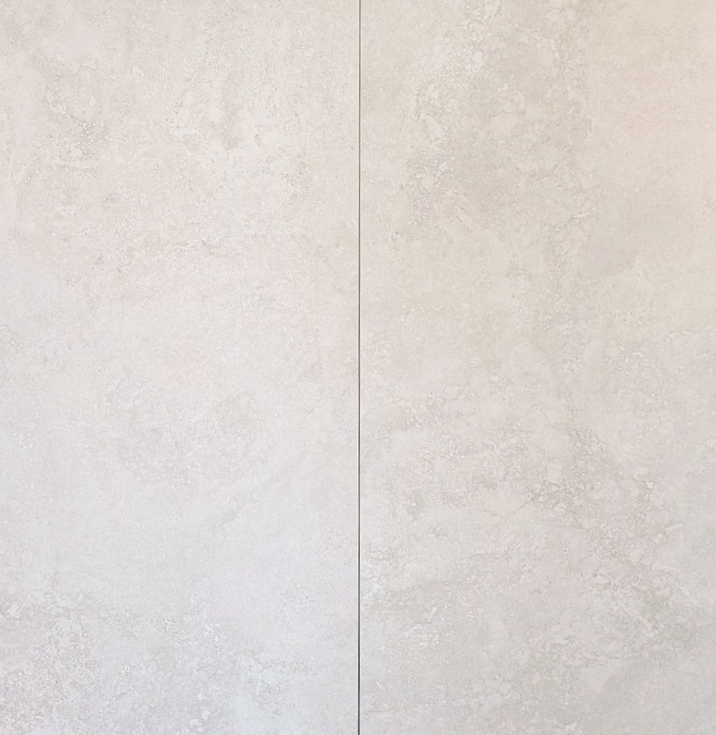 Close-up of a textured white tile with a subtle pattern