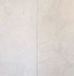 Close-up of a textured white tile with a subtle pattern