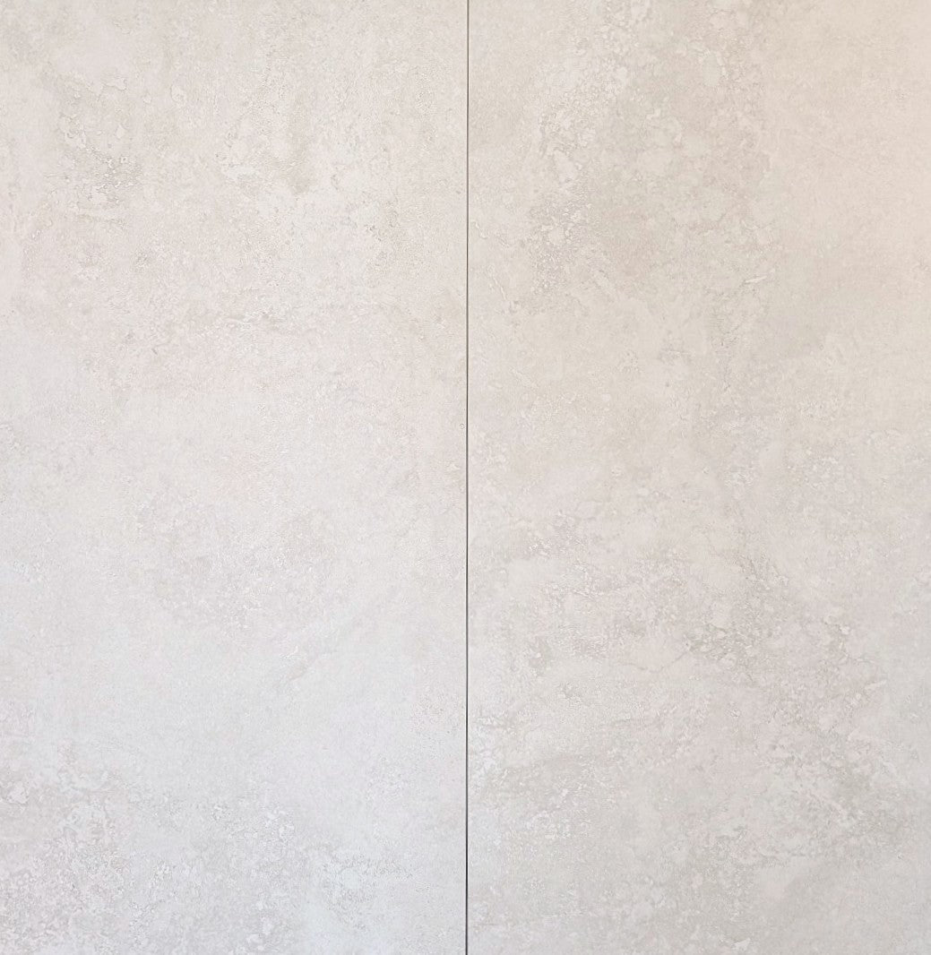 Close-up of a textured white tile with a subtle pattern